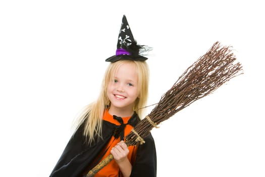 Photo of girl in halloween costume and broom smilling at camera
