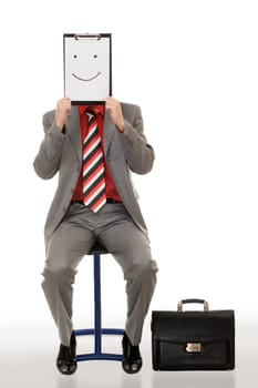 Portrait of businessman holding document with smile near his face