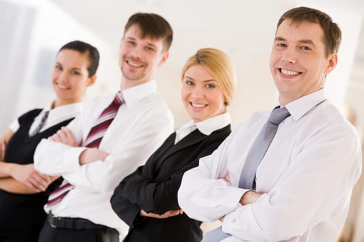 Portrait of happy leader looking at camera in front of his business team