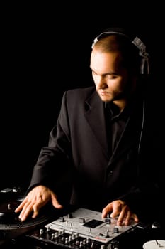 Portrait of handsome deejay at work spinning turntables