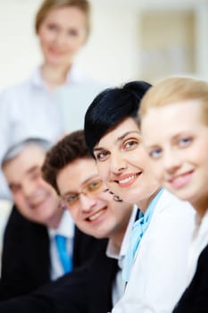 Confident businesswoman looking at camera among her colleagues