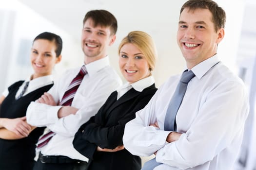 Portrait of happy leader looking at camera in front of his business team