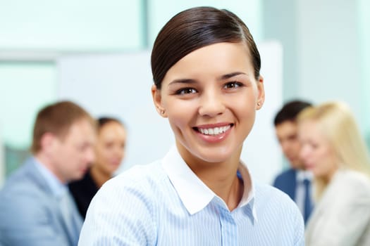 Portrait of smart employer looking at camera in working environment