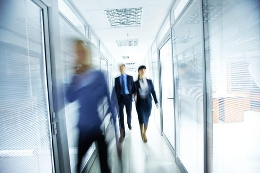 Business people walking in the office corridor