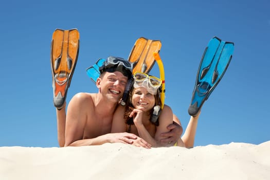 Portrait of cheerful couple in aqualungs looking at camera with smiles