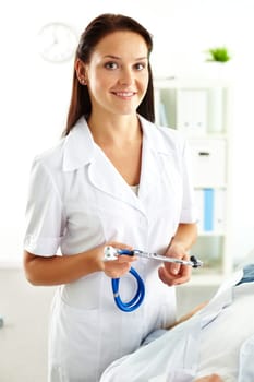 Portrait of confident female doctor with stethoscope looking at camera in hospital
