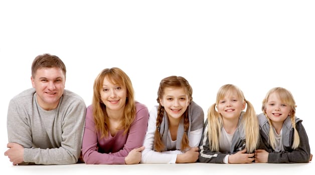 A young friendly family looking at camera on white background
