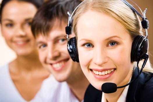 Pretty Customer Support Representative  with a smile on the background of people