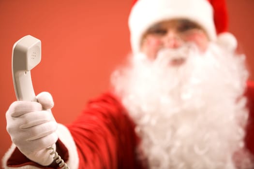 Photo of Santa Claus giving phone receiver to you