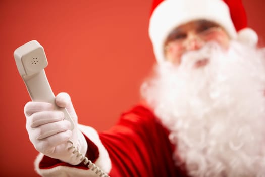 Photo of Santa Claus giving phone receiver to you