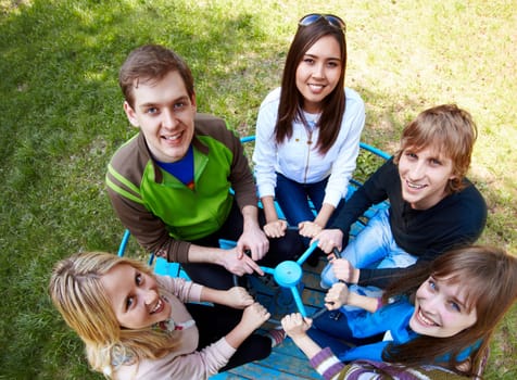 Circle of happy friends looking at camera with smiles at leisure