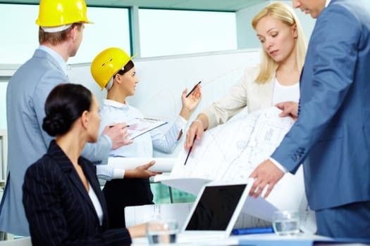 Group of architects interacting in office at meeting