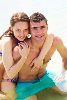 Portrait of happy couple on summer vacation looking at camera