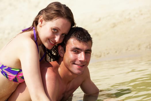 Portrait of happy couple on summer vacation looking at camera