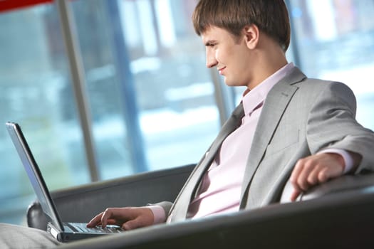 Side view of a businessman working on computer