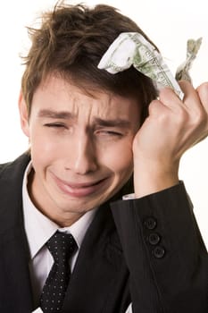 Photo of grieving businessman with crumpled banknote in his hand