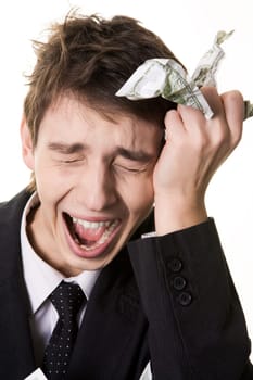 Image of crying businessman touching his head and holding crumpled dollar note in hand