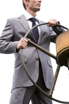 Image of powerful businessman standing and holding steer
