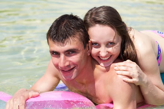 Portrait of happy couple looking at camera with smiles