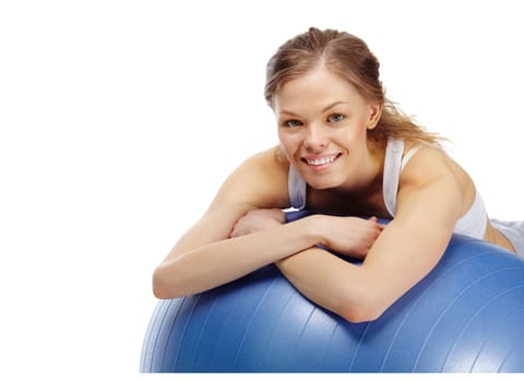 Portrait of a young girl on gymnastic ball looking at camera and smiling