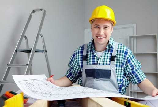 Portrait of a smiling architect holding finished project