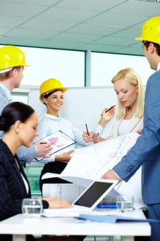 Group of architects sharing ideas in office