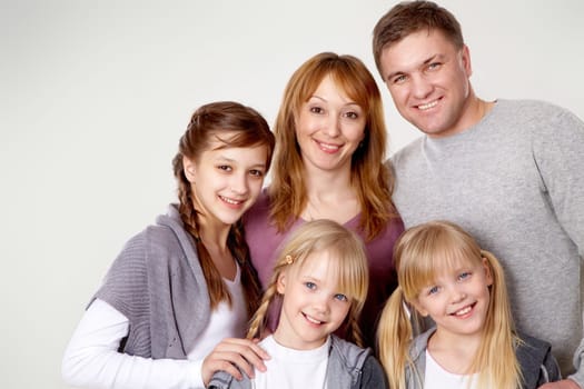 A young friendly family looking at camera