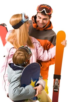 Portrait of happy family with snowboards and skis looking at each other and chatting