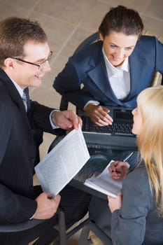 Portrait of three businesspeople discussing a new important project