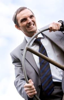 Portrait of strong leader steering on background of sky