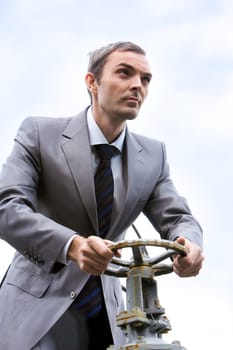 Portrait of strong leader steering on background of sky