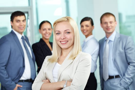 Young colleague against other businesspeople