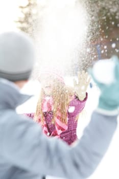 Image of attractive young woman flinging the snowball and having fun
