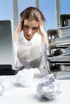 Image of tired businesswoman sitting at her workplace after hard working day