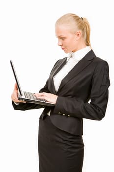 Portrait of businesswoman holding laptop and reading information from its display