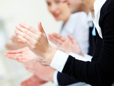 Photo of business partners hands applauding at meeting
