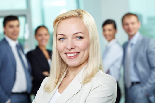 Young pretty businesswoman looking at camera and smiling