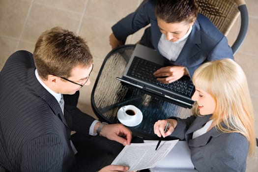 Woman is demonstrating a business text to man at meeting
