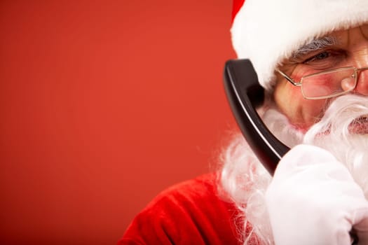 Photo of happy Santa Claus communicating by telephone