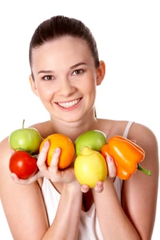 Portrait of pretty girl holding different fruits and vegetables in hands