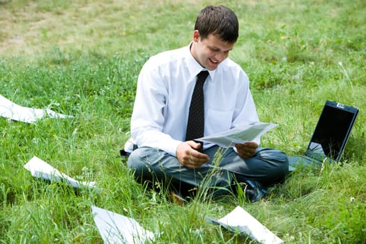Photo of smiling  businessman holding document and thinking about work