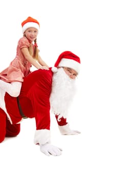 Image of cute girl sitting on Santa back and both looking at camera