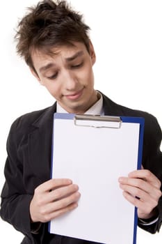 Portrait of young man with paper announcement in hands looking at it curiously