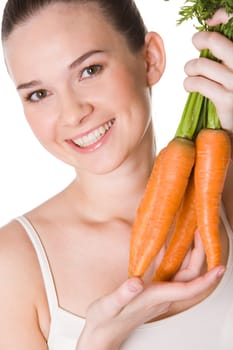 Portrait of pretty girl with ripe carrots smiling at camera over white background
