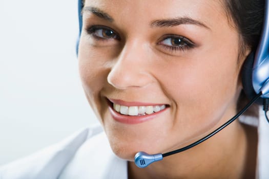 Portrait of  beautiful smiling telephone operator with headset