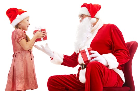 Image of cute girl taking Christmas present from Santa