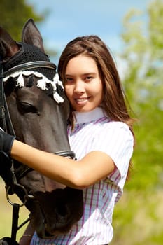 Image of happy female with purebred horse near by