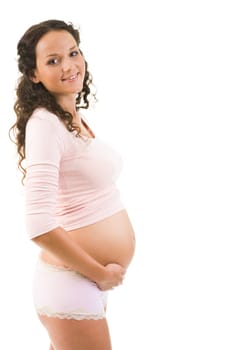 Portrait of pretty pregnant woman wearing tanktop and panties over white background