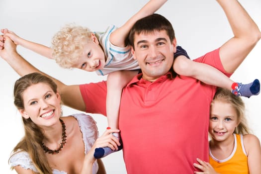 Image of smiling family posing in front of camera