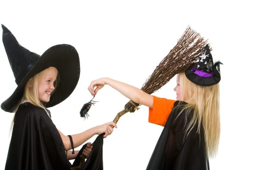 Portrait of girl in warlock scaring her sister by creepy spider